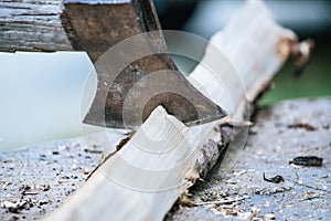Getting wood for fire: Sharp axe cutting wood on a block
