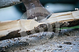 Getting wood for fire: Sharp axe cutting wood on a block