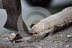 Getting wood for fire: Sharp axe cutting wood on a block