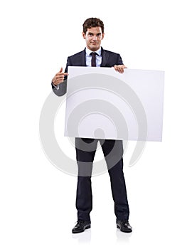 Getting your attention with a large sign. A handsome young businessman holding a large placard.
