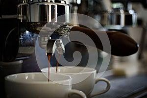 Getting your perfect drink. Coffee being brewed in coffeehouse or cafe. Coffee cups. Small cups to serve hot coffee photo