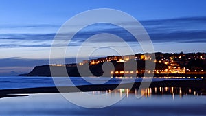 Getxo beach at night with water reflections photo