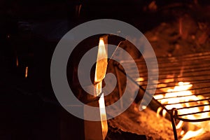 A geyser coffee machine near the fire. Picnic in nature. Camping in the mountains. Night coffee in the forest