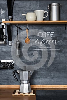 Geyser coffee maker on the background of a dark chalky kitchen wall in a loft-rustic style