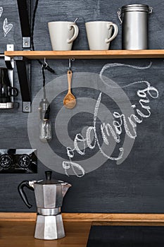 Geyser coffee maker on a chalky kitchen wall background in a loft style. The inscription `Good Morning`