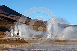 Geyser field with volcano in background, Chile