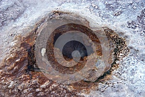 Geyser hole with colored sediments