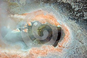 Geyser hole with orange sediments