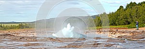 Geysir, Iceland - July 28, 2021: Geyser Strokkur in iceland errupting with hot water and steam, each year many tourists visit the