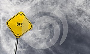 GEZ - yellow sign with cloudy background