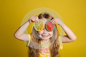 Ggirl standing on yellow background and closing eyes