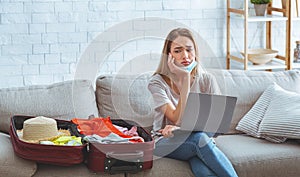 Ggirl with suitcase with clothes and laptop