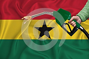 GHANA flag Close-up shot on waving background texture with Fuel pump nozzle in hand. The concept of design solutions. 3d rendering