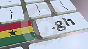 Ghanaian domain .gh and flag of Ghana on the buttons on the computer keyboard. National internet related 3D animation