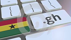 Ghanaian domain .gh and flag of Ghana on the buttons on the computer keyboard. National internet related 3D rendering