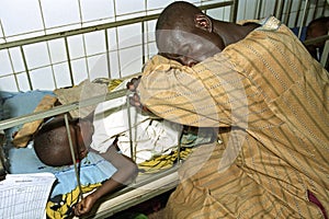 Ghanaian father is guarding his sick child in hospital