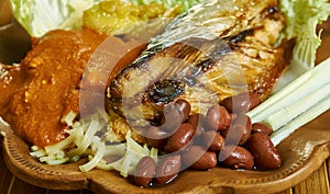 Ghanaian Kenkey with fried fish and chili pepper