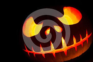 Ghastly Halloween pumpkin head jack lantern on black background