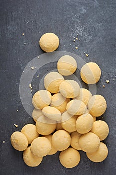 ghee biscuits or cookies scattered on textured surface