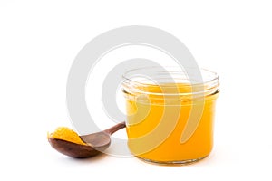 Ghee or clarified butter in jar and wooden spoon isolated photo