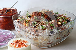 Ghee rice and chicken roast. A rice dish made of basmati rice, ghee, spices and garnished with fried onions, cashews and raisins. photo