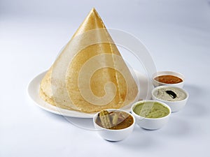 Ghee roast dosai with sambar and three type chutneys on a white background