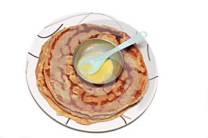 Ghee and spoon on Puran Poli photo