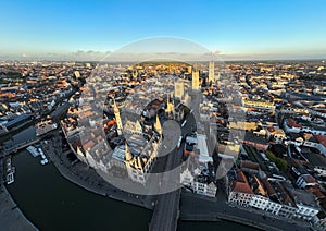 Ghent Belgium Aerial Flying over downtown area with church cityscape views at sunset time - October 2022