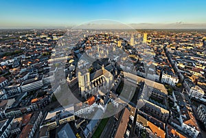 Ghent Belgium Aerial Flying over downtown area with church cityscape views at sunset time - October 2022