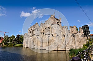 Ghent, Belgium, August 2019. The Gravensteen is the castle of the counts of Flanders. View from the side of the moat: the imposing