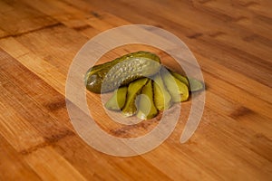Gherkins cucumber pickled slice isolated on wooden table top view of indian food