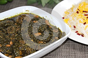 Ghormeh Sabzi or mixed vegetables served in a dish isolated on wooden background side view