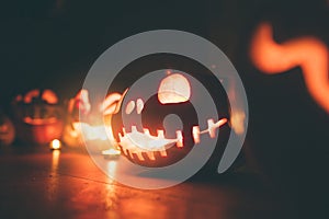 Ghost pumpkins on Halloween. ead Jack on Dark background. Holiday indoor decorations.