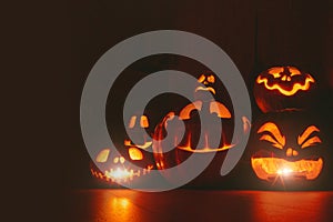 Ghost pumpkins on Halloween. ead Jack on Dark background. Holiday indoor decorations.