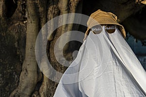 ghost standing around vegetation in broad daylight, at sunset, mexico