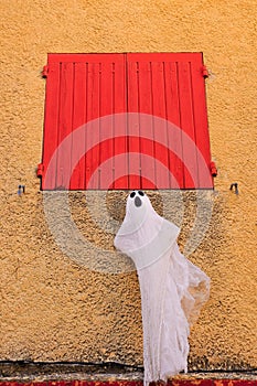 ghost under red, wood, shutters
