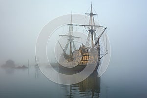 ghostly pirate ship emerging from eerie fog