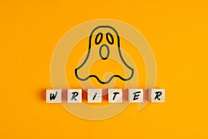 Ghostwriter concept with a ghost symbol and the word writer on wooden blocks