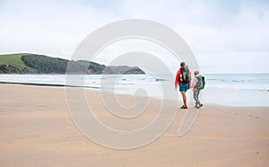 Giant beach of Biskay Bay, North Spain. Mother and son Camino de photo