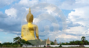 A giant Buddha statue looks out over downtown Thailand at sunset from Bongeunsa Temple.