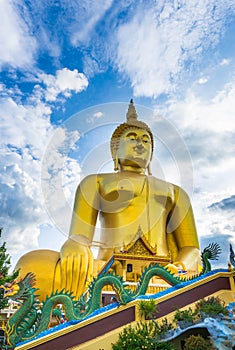 A giant Buddha statue looks out over downtown Thailand at sunset from Bongeunsa Temple.
