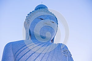 Giant Buddha statue on top of tropical island mountain in asia