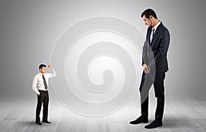 Giant businessman scared of small businessman