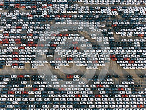 Giant car parking aerial view, cars are standing in straight rows on the asphalt