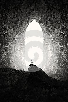 Giant cave entrance with man silhouette