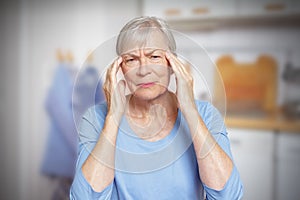 elderly woman headache migraine hypertension photo