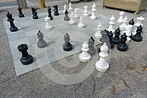 Giant chess set and figures in a city square