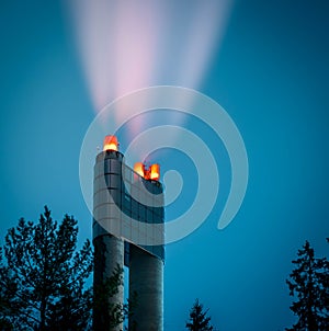 A giant chimney in a garbage incinerator at night