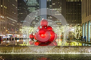 Giant Christmas Ornaments on a Fountain in New York Manhattan at Night. Big Balls and Bright Lights Decoration