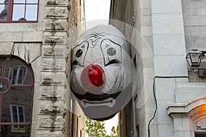 Giant clown head balloon from the Endgame Nadd & Nell Max Streicher installation between two buildings